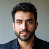 Professional headshot of Thiago Ferreira, a man with a focused and creative look.